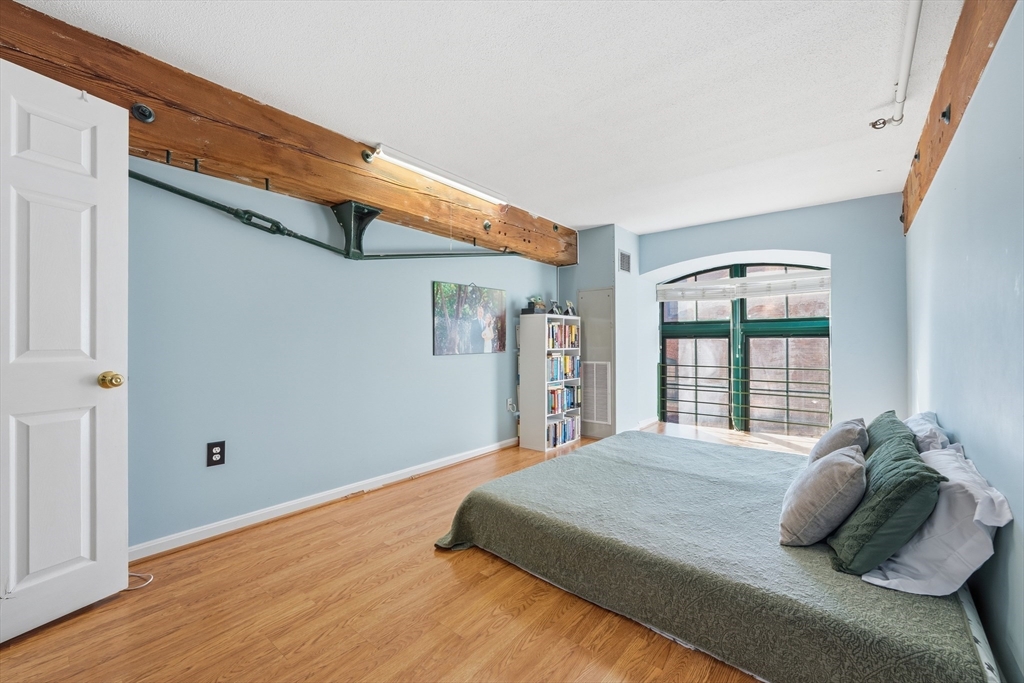 200 Market Street, Unit 217 Lowell, MA 01852 - Photo 19 of 38 a bedroom with a large bed and a window