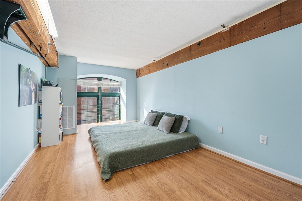 200 Market Street, Unit 217 Lowell, MA 01852 - Photo 20 of 38 a bedroom with a bed and a window