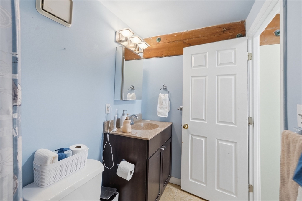 200 Market Street, Unit 217 Lowell, MA 01852 - Photo 28 of 38 a bathroom with a sink vanity and mirror