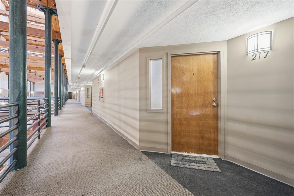 200 Market Street, Unit 217 Lowell, MA 01852 - Photo 29 of 38 a view of a hallway with windows