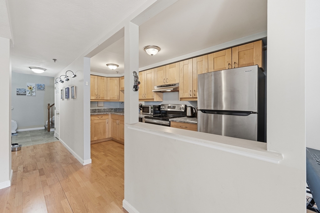 200 Market Street, Unit 217 Lowell, MA 01852 - Photo 4 of 38 a kitchen with stainless steel appliances a refrigerator and a stove top oven