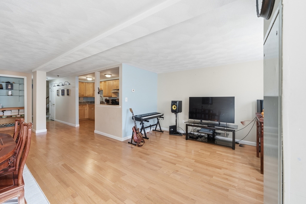 200 Market Street, Unit 217 Lowell, MA 01852 - Photo 6 of 38 a living room with furniture and a flat screen tv