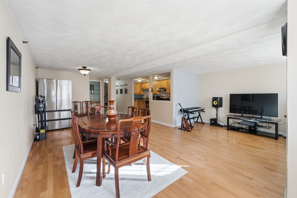 200 Market Street, Unit 217 Lowell, MA 01852 - Photo 7 of 38 a view of a dining room with furniture and wooden floor