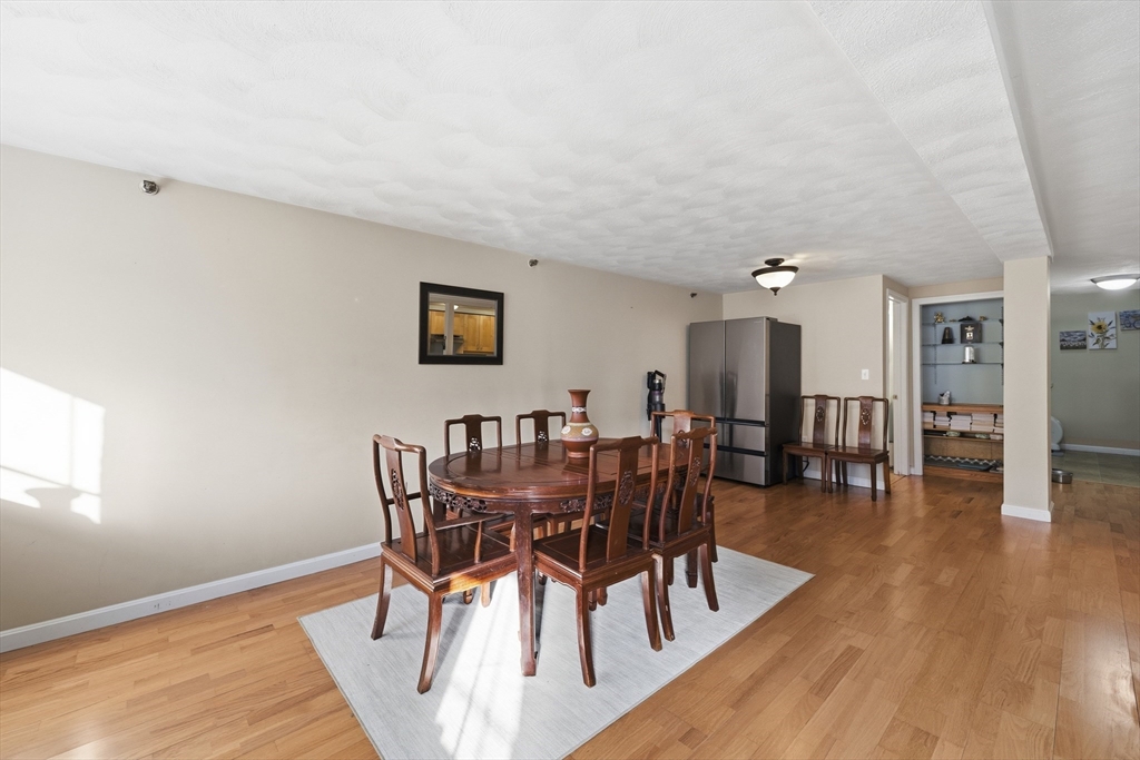 200 Market Street, Unit 217 Lowell, MA 01852 - Photo 8 of 38 a view of a dining room with furniture and wooden floor