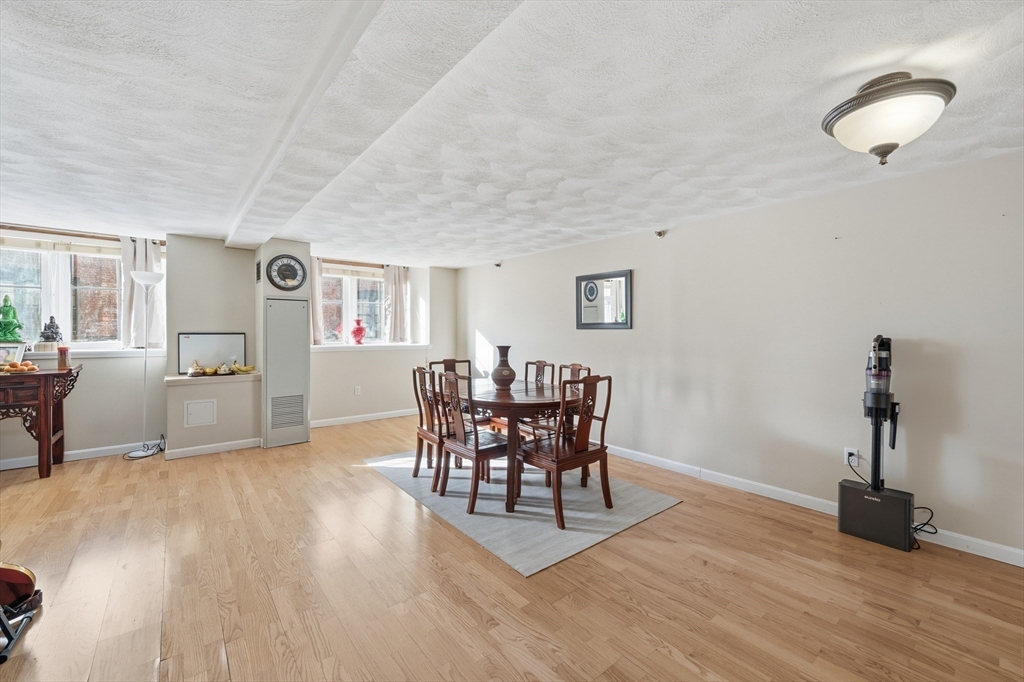200 Market Street, Unit 217 Lowell, MA 01852 - Photo 9 of 38 a view of a livingroom with furniture and wooden floor