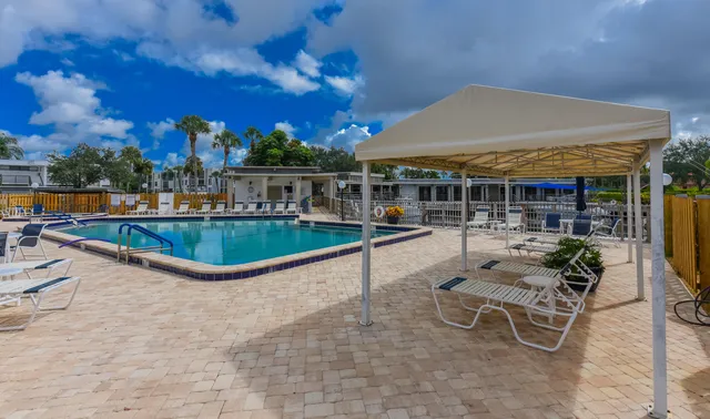 a view of a patio with swimming pool table and chairs
