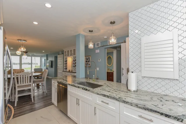 a large white kitchen with a large window
