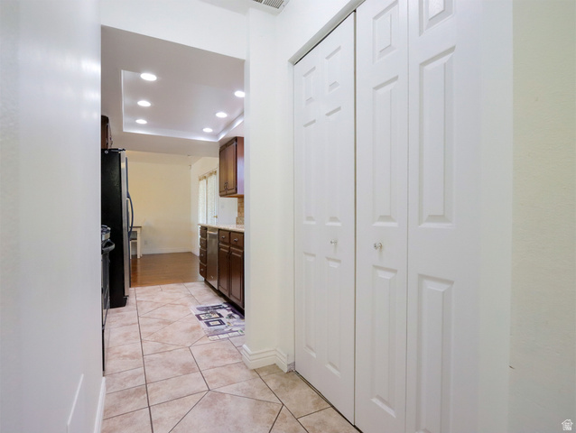 270 East 100 North Monroe, UT 84754 - Photo 18 of 65 Hallway featuring light-toned square and diamond pattern tile flooring, white walls, and bi-fold panel doors