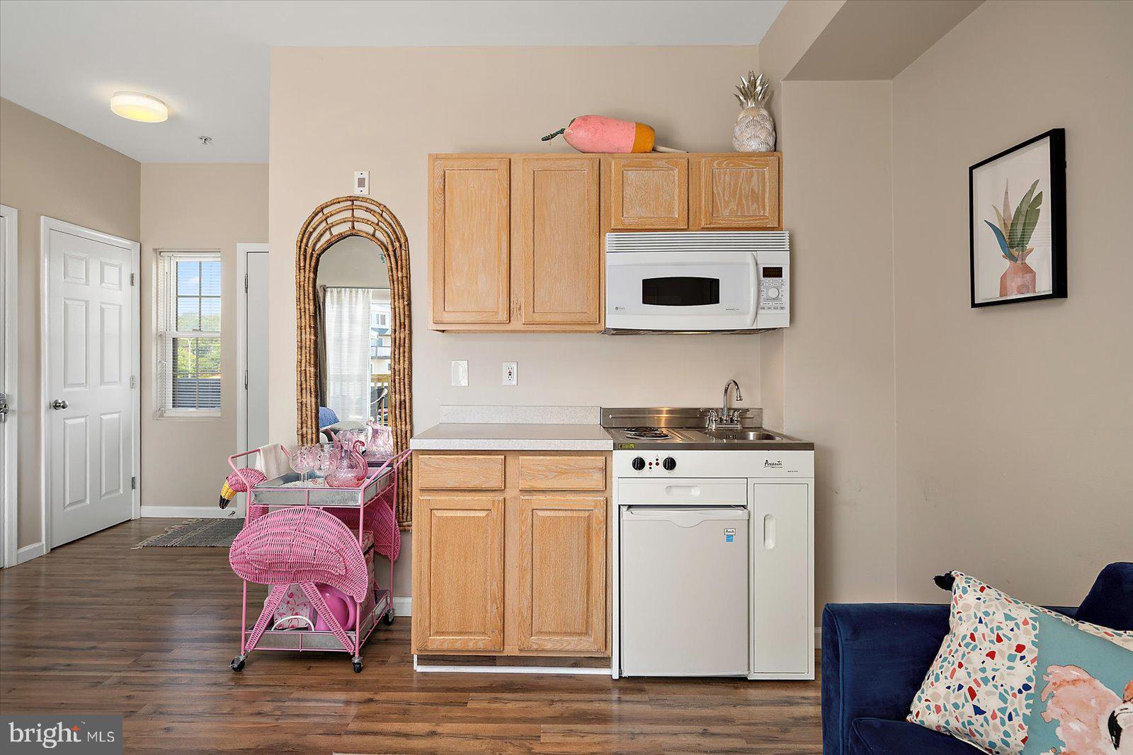 39634 Jefferson Bridge Road, Unit 104 Bethany Beach, DE 19930 - Photo 13 of 28 a kitchen with a sink cabinets and wooden floor