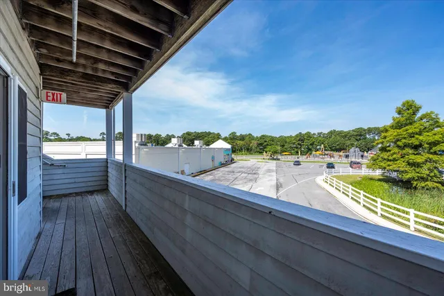 a view of a balcony with wooden floor