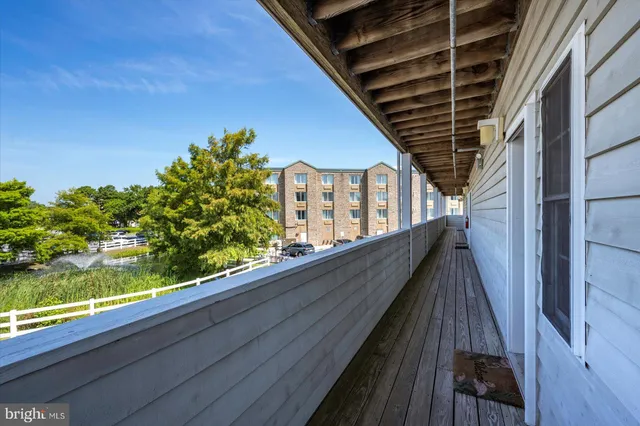 a view of balcony with wooden floor and fence