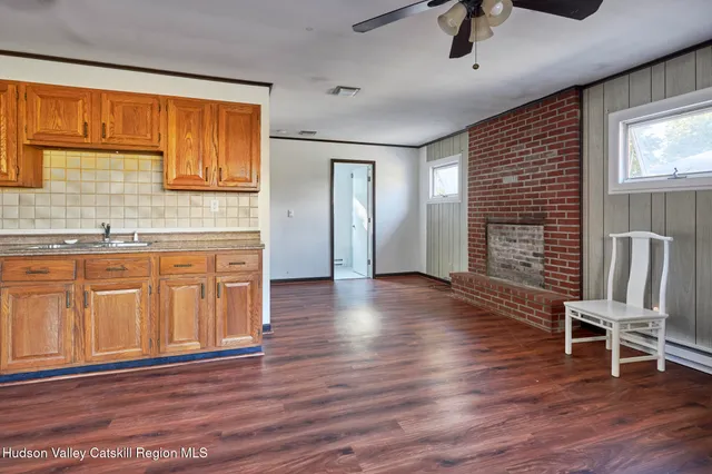 a view of a livingroom with furniture and hardwood floor