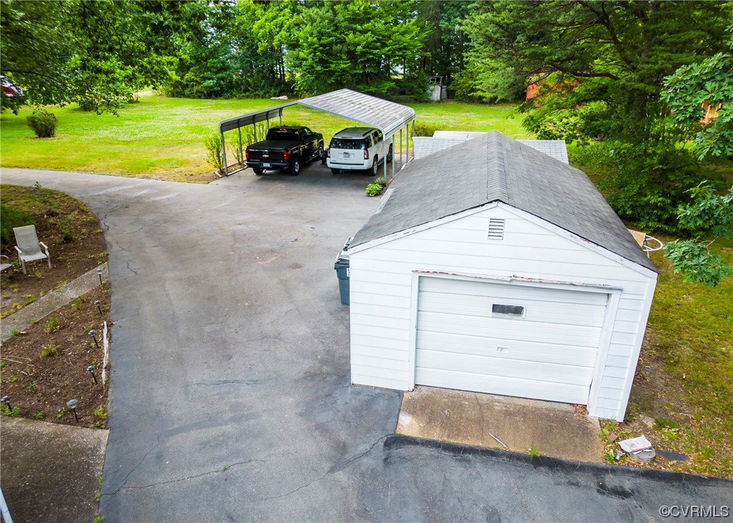 7654 Elkhardt Road Richmond, VA 23225 - Photo 29 of 48 Garage featuring a yard, carport, and garage