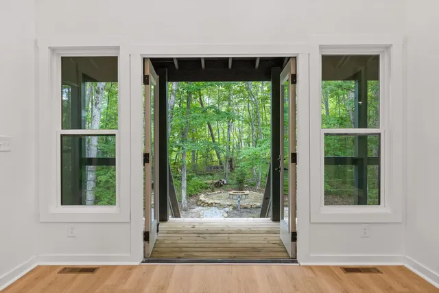 a view of kitchen with refrigerator and window