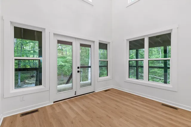 a view of kitchen with wooden floor and electronic appliances