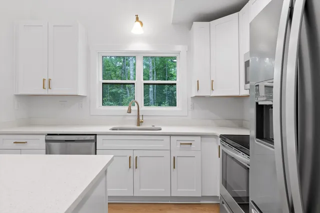 a kitchen with a sink stove and refrigerator