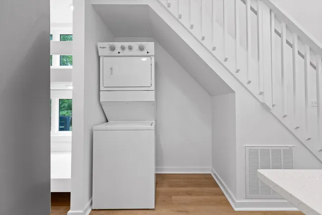 a hallway with a wooden floor and a window