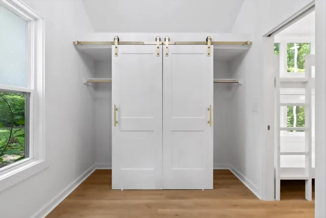 wooden floor in an empty room with a window