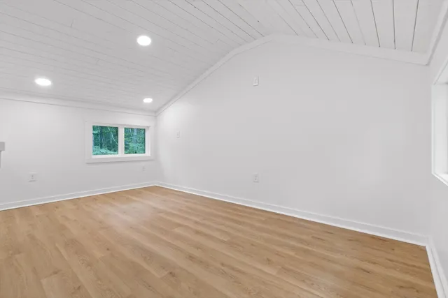 an aerial view of residential house with outdoor space and trees all around
