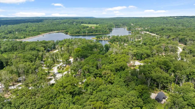 a view of a lake with a house in the background