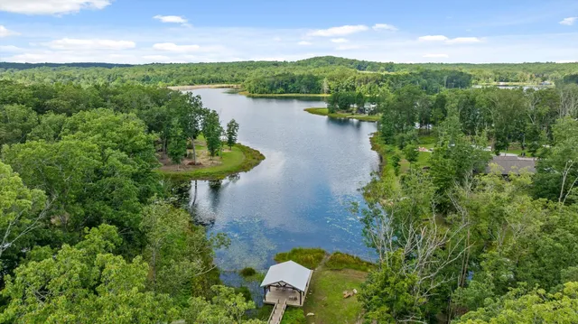 a view of a lake with a house in the background