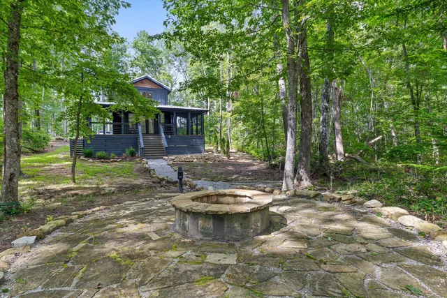 a view of a backyard with table and chairs and wooden fence