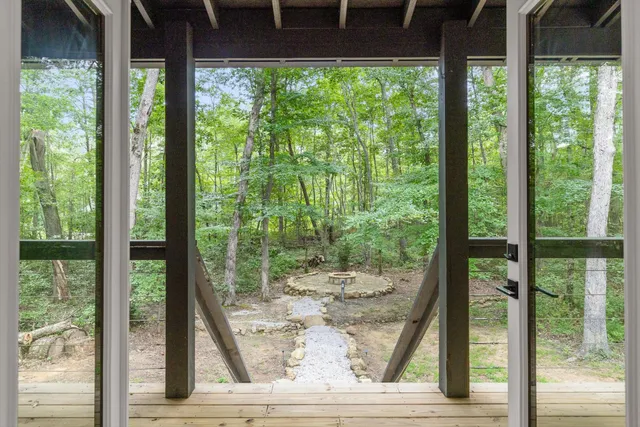 a view of a room with wooden floor and outdoor space