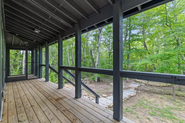 a view of empty room with wooden floor and walls