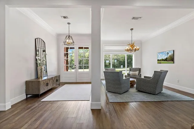 a living room with furniture and wooden floor