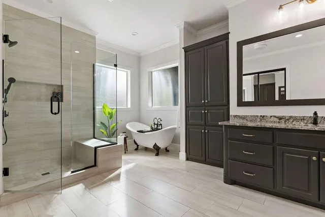 a spacious bathroom with a granite countertop tub sink and mirror