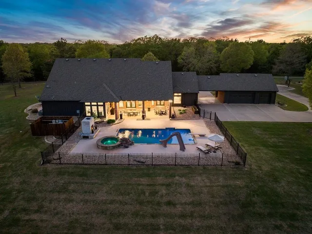 an aerial view of a house with outdoor space swimming pool and mountains