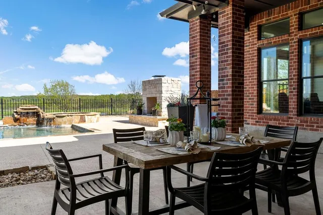 a view of a patio with a table and chairs