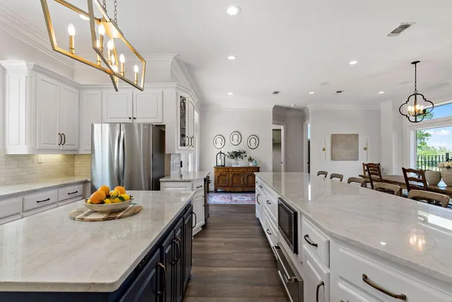 a large kitchen with stainless steel appliances lots of counter space and refrigerator