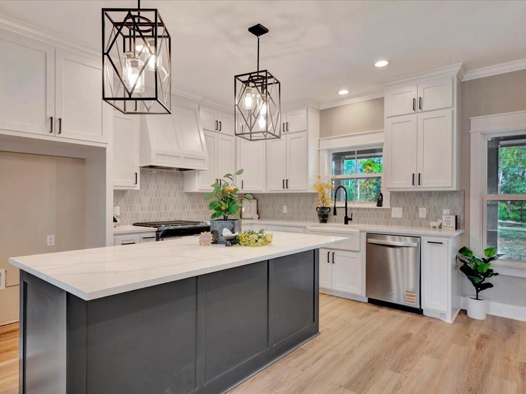 a kitchen with a sink chandelier and stove