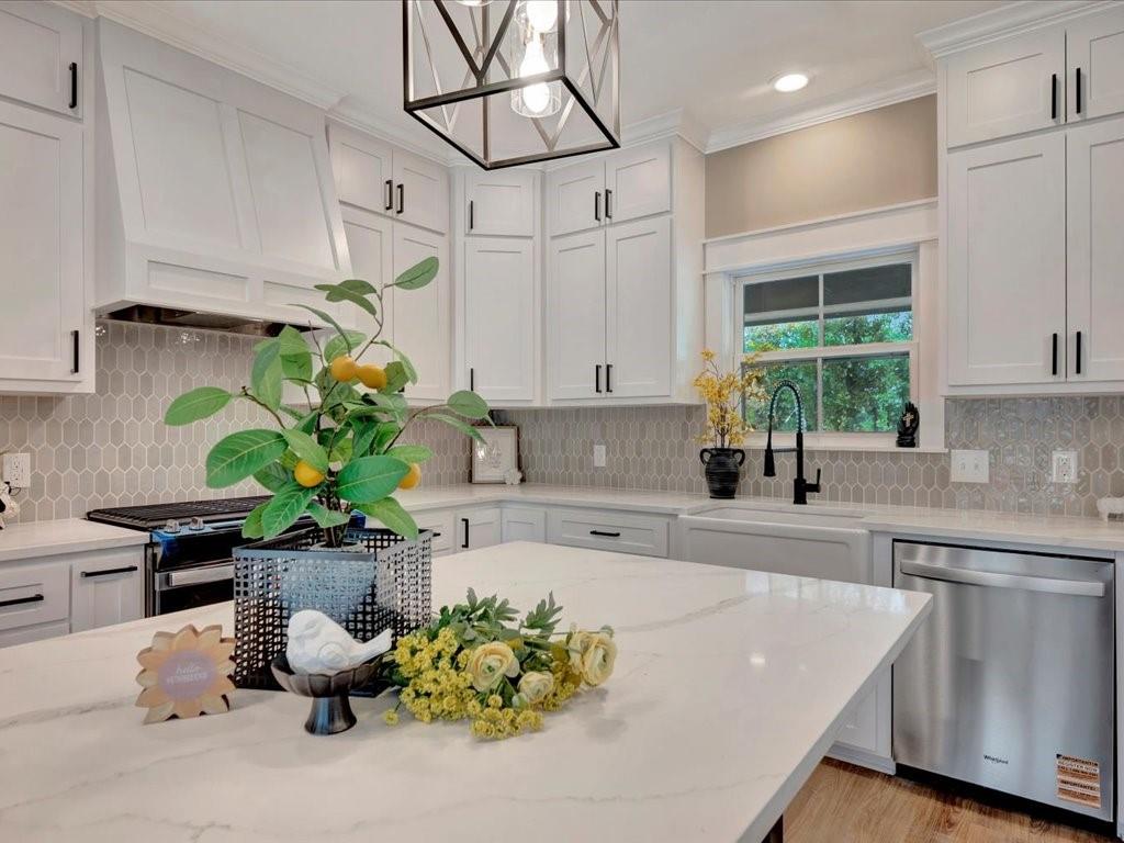 537 C C Road Diboll, TX 75941 - Photo 13 of 37 a kitchen with stainless steel appliances a sink a counter top space cabinets and a potted plant