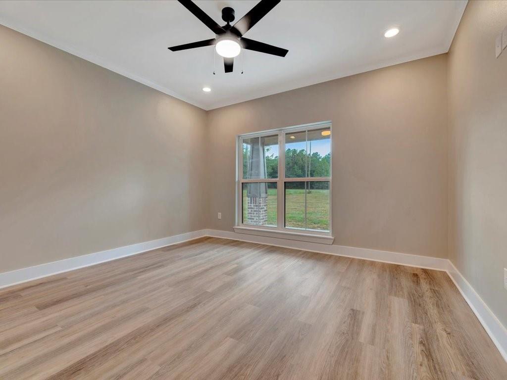 537 C C Road Diboll, TX 75941 - Photo 27 of 37 an empty room with wooden floor and windows