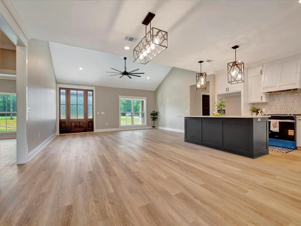 537 C C Road Diboll, TX 75941 - Photo 9 of 37 a view of a kitchen with cabinets and wooden floor