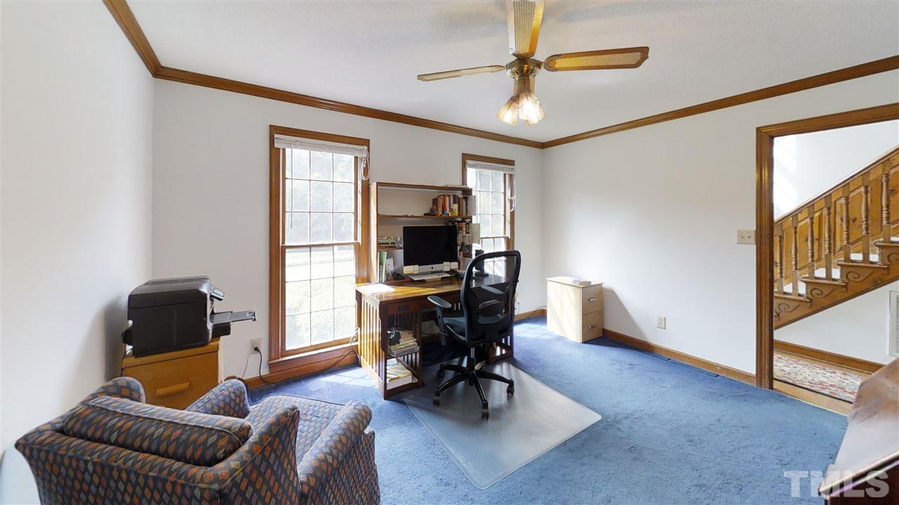 2704 Vestry Way Raleigh, NC 27613 - Photo 11 of 25 a living room with furniture a dining table and chairs with wooden floor