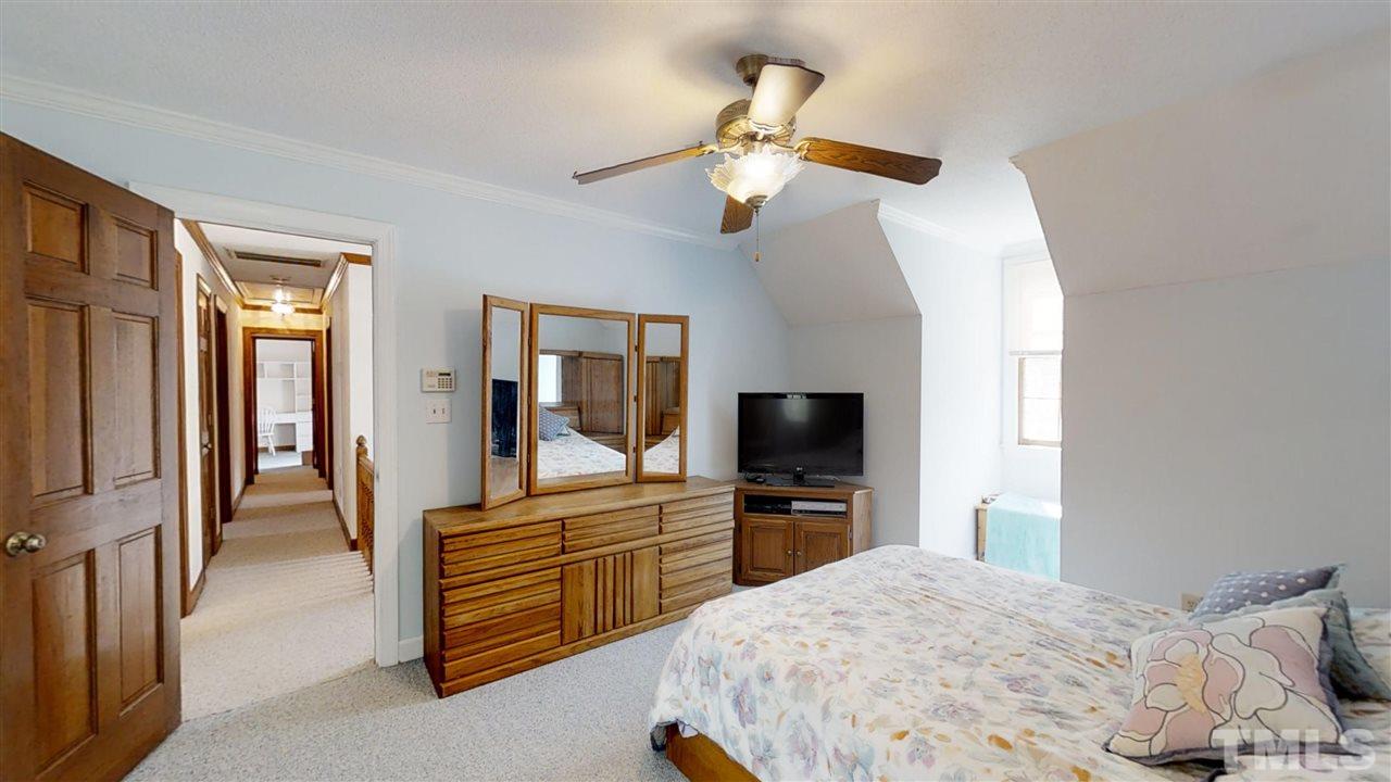 2704 Vestry Way Raleigh, NC 27613 - Photo 14 of 25 a bedroom with a bed and a flat screen tv