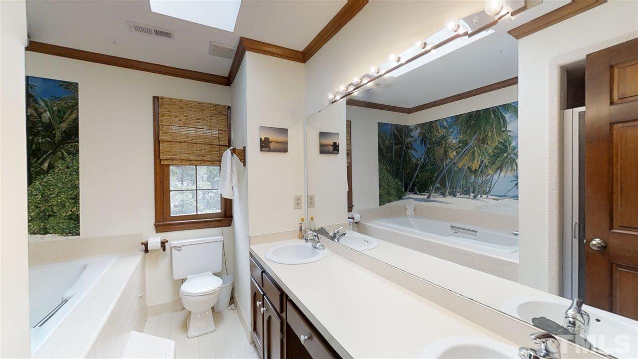 2704 Vestry Way Raleigh, NC 27613 - Photo 16 of 25 a bathroom with a sink toilet and shower