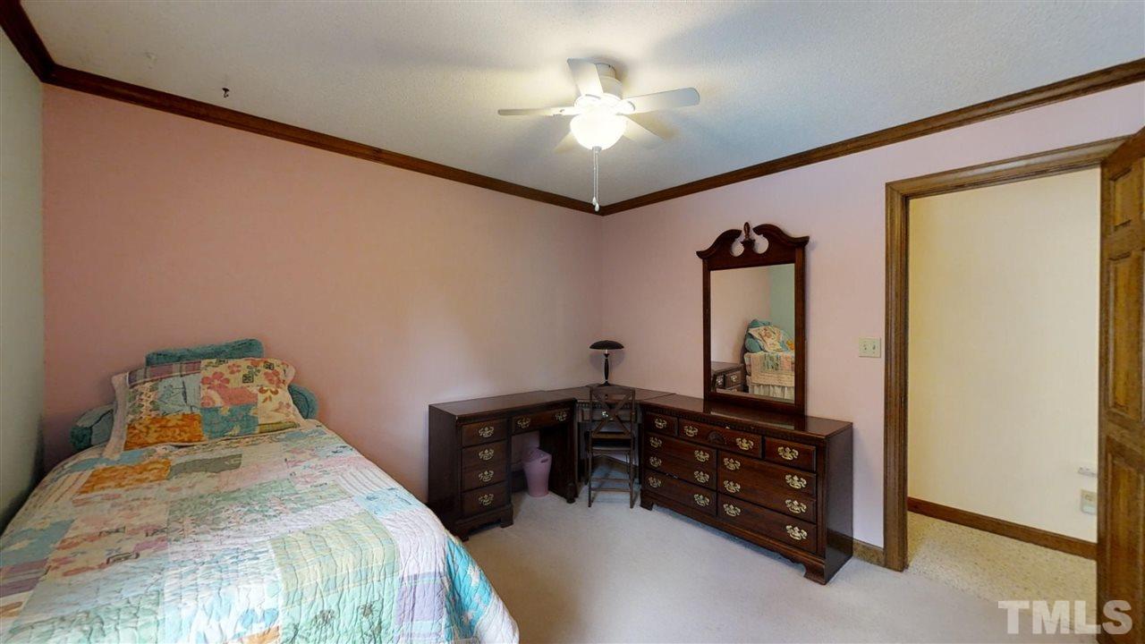 2704 Vestry Way Raleigh, NC 27613 - Photo 17 of 25 a bedroom with a bed and a chandelier