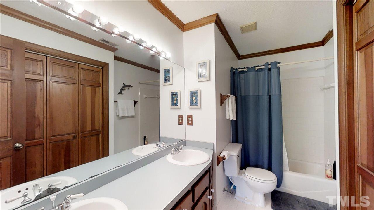 2704 Vestry Way Raleigh, NC 27613 - Photo 20 of 25 a bathroom with a sink toilet and shower