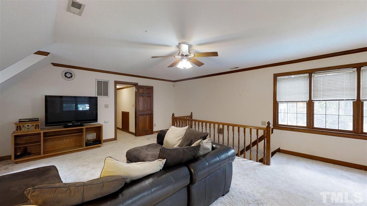 2704 Vestry Way Raleigh, NC 27613 - Photo 22 of 25 a living room with furniture and a flat screen tv