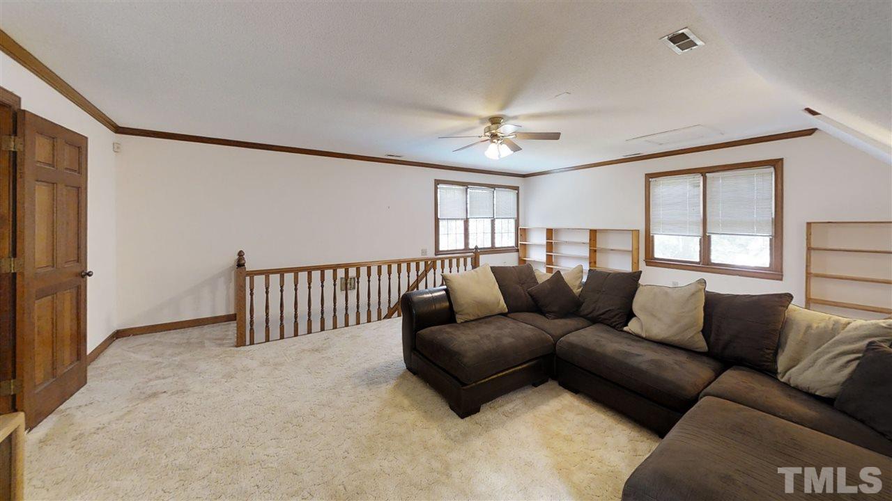 2704 Vestry Way Raleigh, NC 27613 - Photo 23 of 25 a living room with furniture and a window
