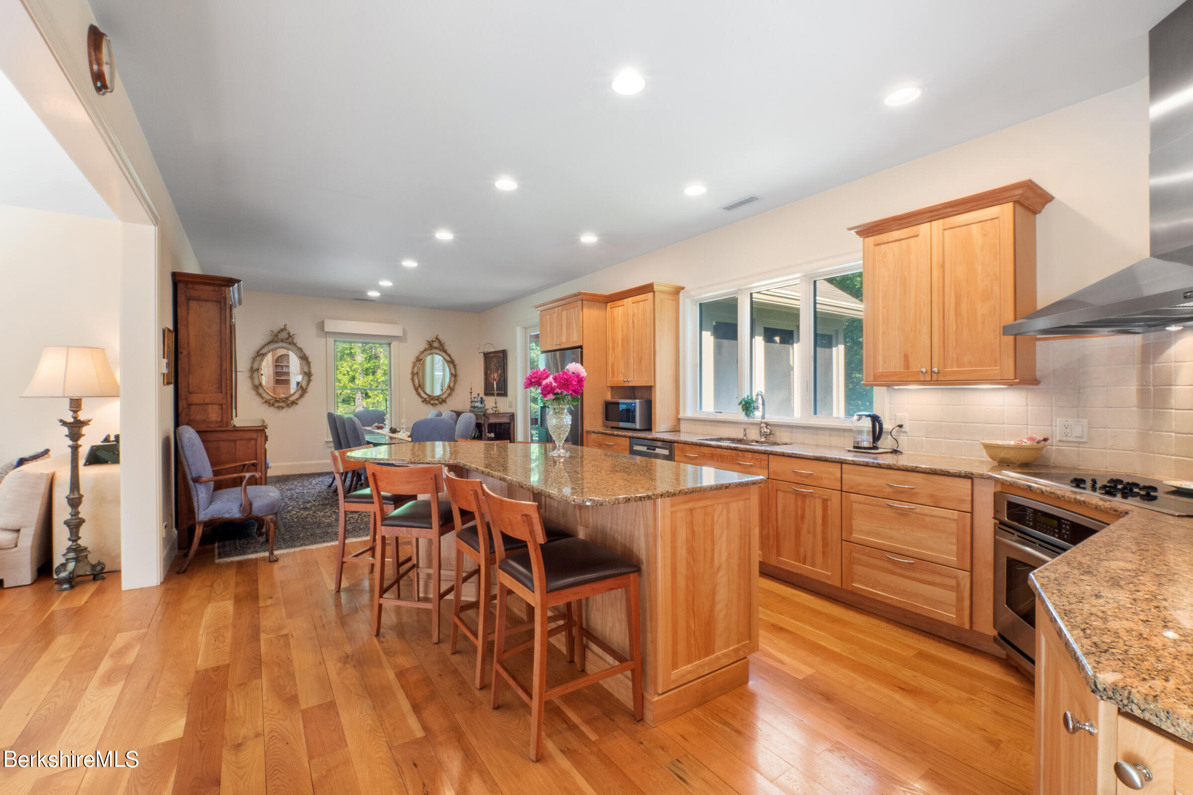 9 East Mountain Road Great Barrington, MA 01230 - Photo 15 of 45 a kitchen with stainless steel appliances granite countertop dining table chairs sink and cabinets