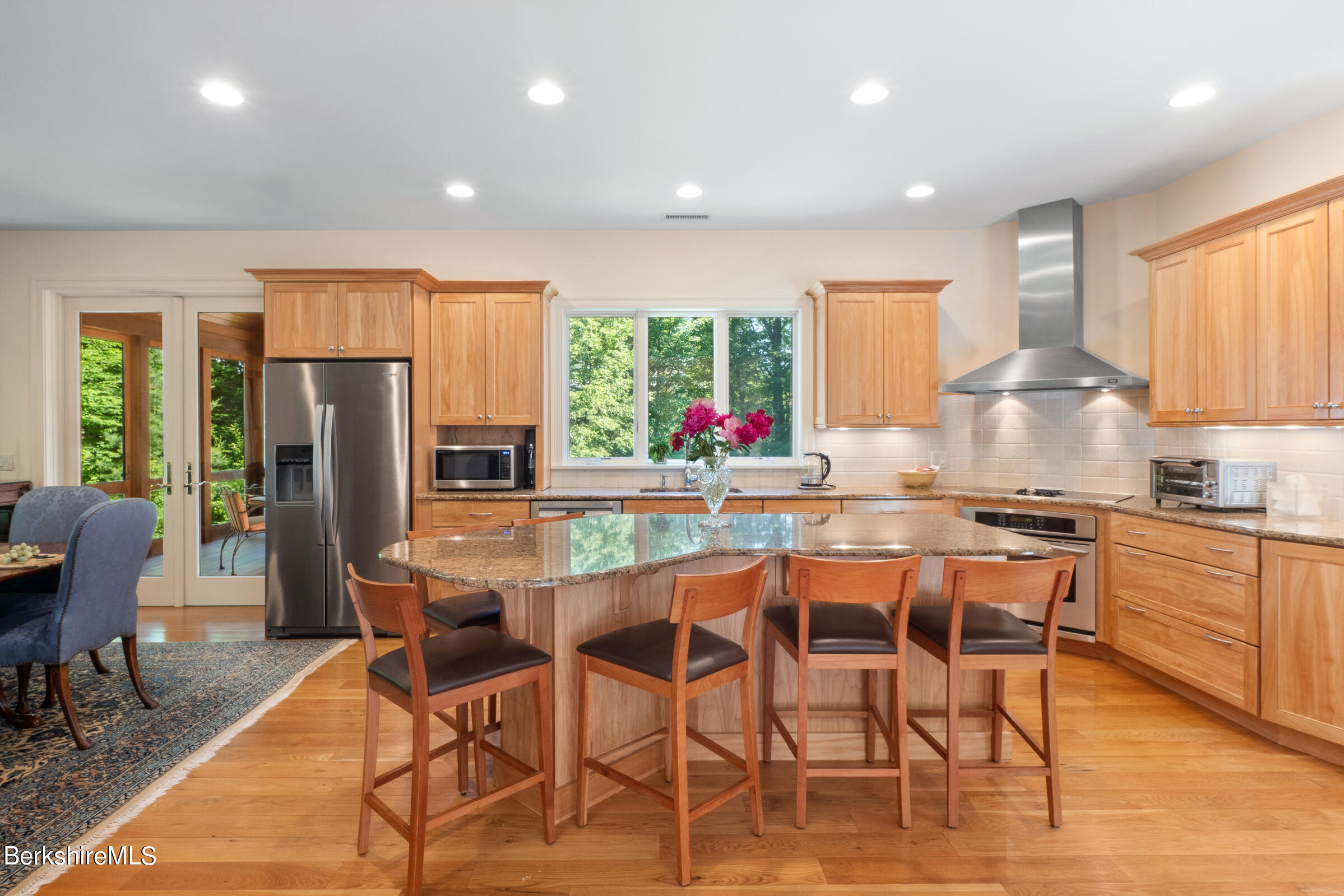 9 East Mountain Road Great Barrington, MA 01230 - Photo 10 of 45 a kitchen with stainless steel appliances kitchen island granite countertop a dining table chairs and granite counter tops