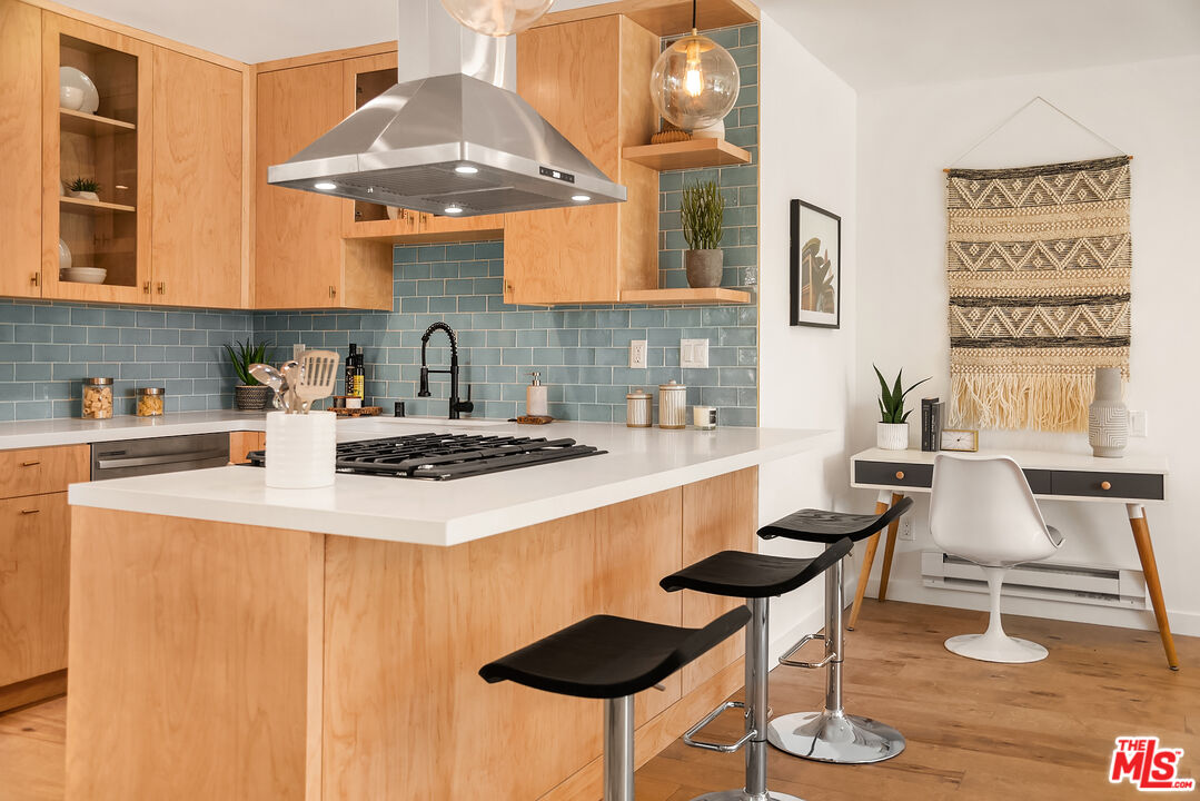 a kitchen with a dining table chairs and stove