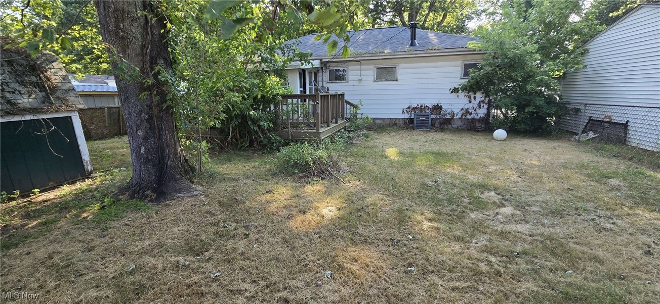 1943 Clyde Road Madison, OH 44057 - Photo 3 of 16 View of green lawn with a wooden deck