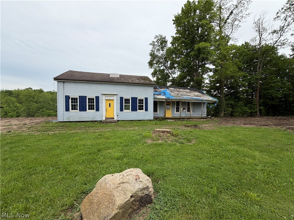 9098 Diagonal Road Streetsboro, OH 44241 - Photo 15 of 25 Two-story residence with light blue siding and a prominent yellow front door, flanked by blue window shutters