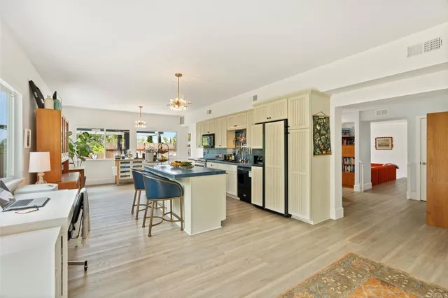 a view of a patio with a table and chairs under an umbrella
